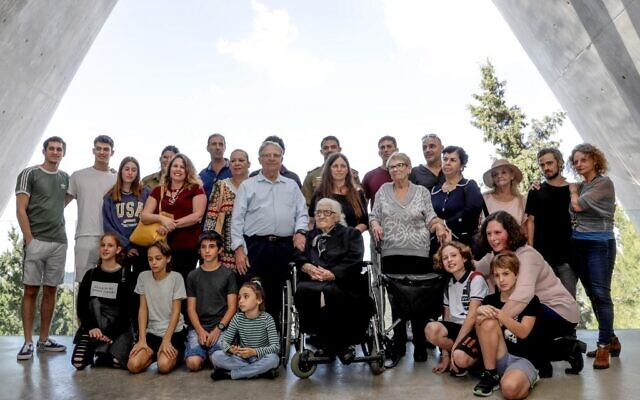 Group of people posing outdoors together.